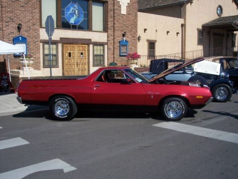 1972 Ford Ranchero - A red 1972 Ford Ranchero is parked on a street with its hood open, alongside other vehicles.