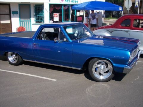 1972 Ford Ranchero - A blue 1964-1965 Ford Ranchero is parked next to a custom car at an outdoor event.
