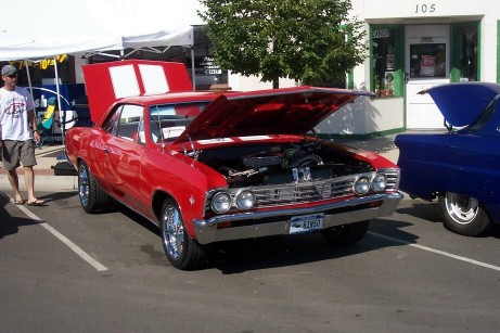 1972 Ford Ranchero - A red 1966 Chevelle coupe is displayed with its hood open, parked next to a blue car.