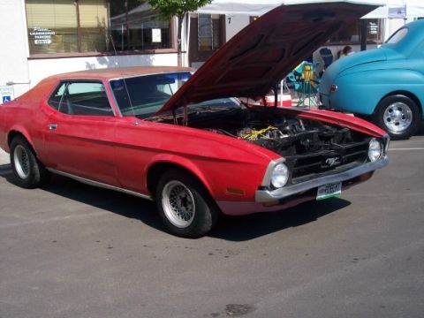 1972 Ford Ranchero - A red 1971 Ford Mustang coupe is parked with its hood open, revealing the engine bay.
