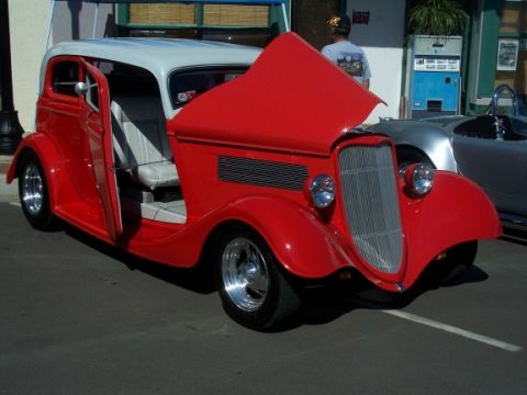 1972 Ford Ranchero - A red and white hot rod coupe is parked on asphalt with its hood and door open.