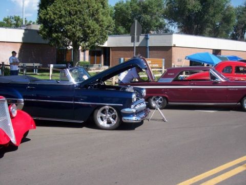 1972 Ford Ranchero - A dark blue convertible is displayed with its hood open, parked next to other vehicles.
