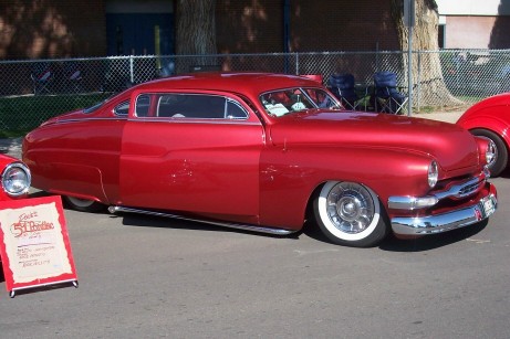 1972 Ford Ranchero - Customized coupe with a lowered stance and classic chrome details is displayed at an event.