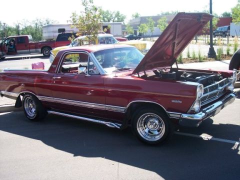 1972 Ford Ranchero - A red Ford Ranchero is parked with its hood up, showing the engine bay.