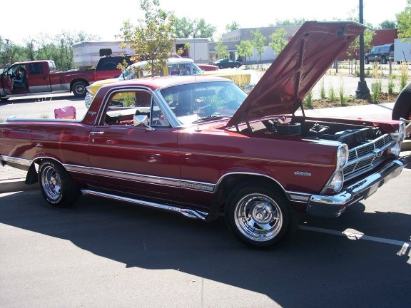 red Ford Ranchero with hood open, parked outside