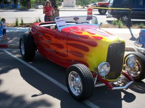 1972 Ford Ranchero - Custom hot rod with flame paint job parked on a street.