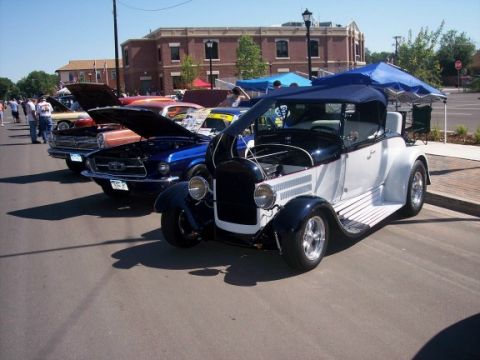 1972 Ford Ranchero - A classic 1920s Ford Model T Roadster is displayed at a car show alongside other vehicles.