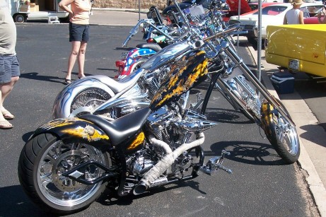 1972 Ford Ranchero - A custom chopper motorcycle with striking flame graphics and extensive chrome detailing is displayed alongside other vehicles.