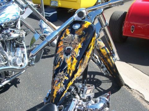 1972 Ford Ranchero - Custom motorcycle with elaborate flame and skull graphics on its fuel tank, parked outdoors.