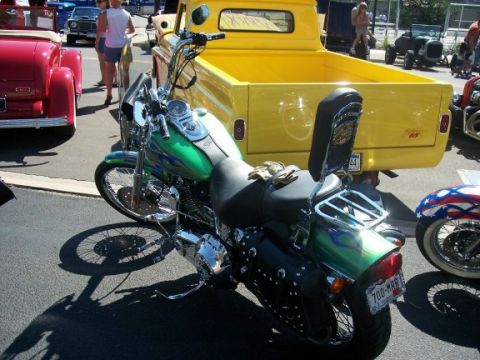 1972 Ford Ranchero - A green motorcycle with flame decals is parked next to a yellow pickup truck.