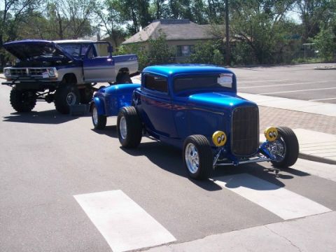 1972 Ford Ranchero - A blue 1932 Ford hot rod coupe is towing a lifted pickup truck.