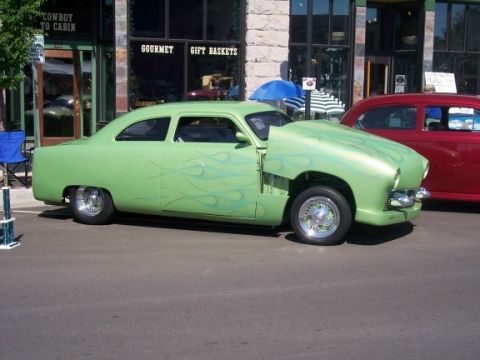 1972 Ford Ranchero - Custom hot rod with flame paint and an open hood sits parked on a street.
