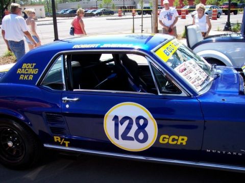 1972 Ford Ranchero - A blue race car with racing decals and number 128 is parked outdoors.