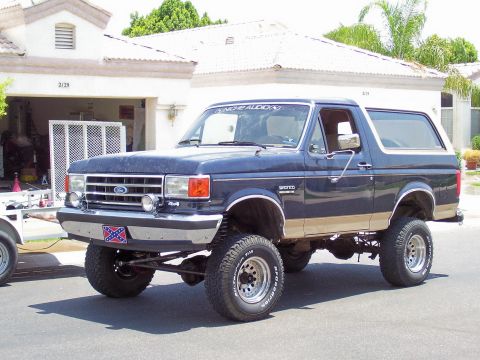 1991 Ford Bronco - This lifted 1991 Ford Bronco features a dark blue exterior with tan trim and BFGoodrich tires.