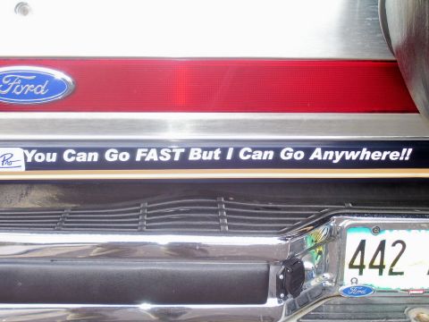 1991 Ford Bronco - A bumper sticker on a Ford vehicle reads 'You Can Go FAST But I Can Go Anywhere!!'.
