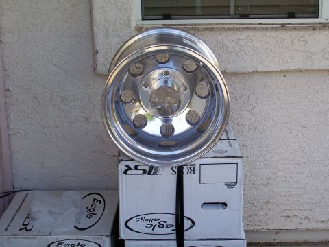 1991 Ford Bronco - A single chrome wheel with a multi-lug pattern is displayed atop several boxes of Eagle Alloys.
