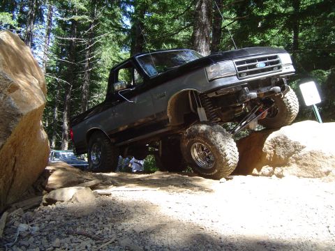 1989 Ford Bronco - Modified 1989 Ford Bronco navigating a rocky off-road trail.
