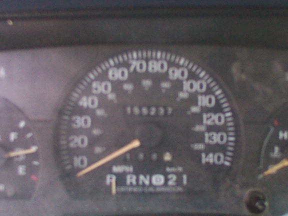 Instrument cluster speedometer reading about 155237 miles, gear indicator P R N D 2 1