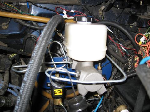 1994 Ford Bronco - The brake master cylinder and reservoir are visible, along with numerous brake lines and electrical wiring.
