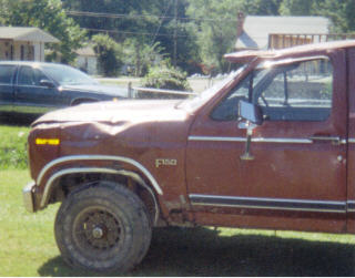 1984 Ford F-150 - This 1980s Ford F-150 pickup shows significant front-end damage.