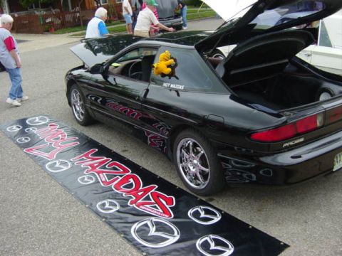1995 Ford Probe - Black 1995 Ford Probe on display at a car show with its hood and trunk open.