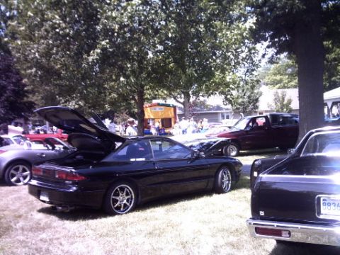 1995 Ford Probe - A black 1995 Ford Probe is displayed with its hoods open at an outdoor event, alongside other vehicles.