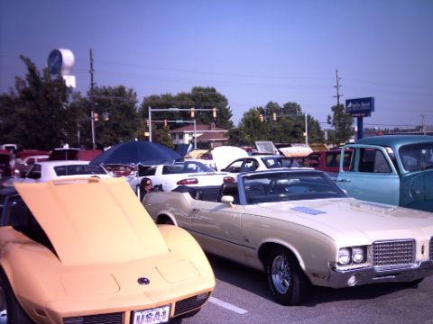 1995 Ford Probe - Several vintage cars are parked at an outdoor event under a clear blue sky.