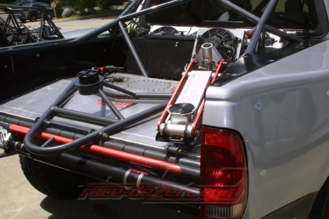 1984 Ford Bronco - This custom off-road truck features a reinforced bed with a roll cage, a hydraulic jack, and cooling fans.