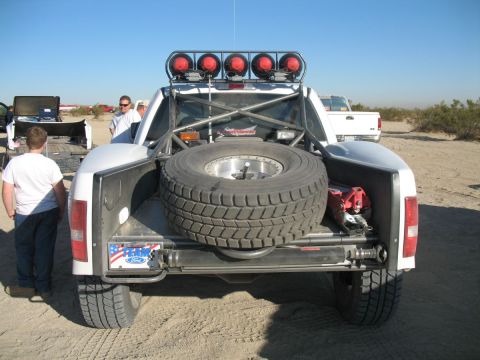 1984 Ford Bronco - This modified truck features a large spare tire and a roll cage, suggesting it's built for off-road racing.