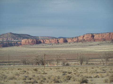 1995 Ford Probe - Wide desert scene with mesas and a road, likely taken from a vehicle.