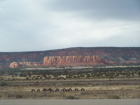 1995 Ford Probe - A wide view of a desert scene with prominent rock formations and a cloudy sky.