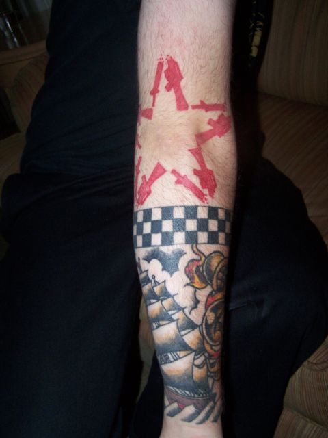 1995 Ford Probe - A tattoo features a red star formed by guns, a checkered band, and a sailing ship on an arm.