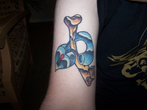 1995 Ford Probe - Tattoo on an arm features a stylized bone and heart design.