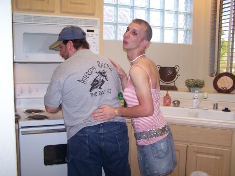 1995 Ford Probe - A man and another person are in a kitchen, with the person in the striped top's arm around the man's waist.