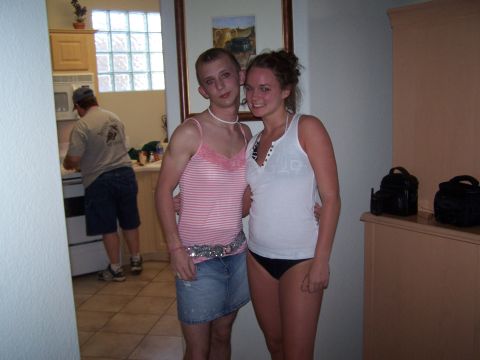 1995 Ford Probe - Two individuals pose for a photo indoors, with a person in the background visible in a kitchen area.