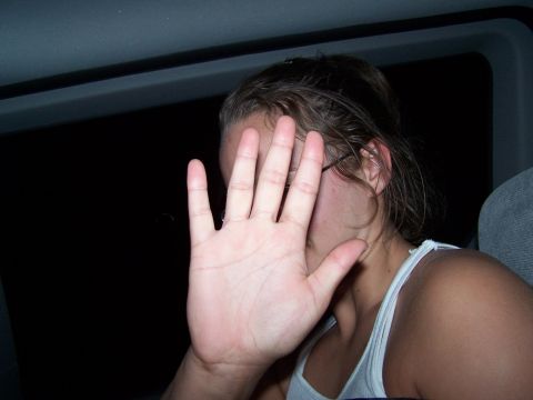 1995 Ford Probe - A person inside a vehicle shields their face from the camera with their hand.
