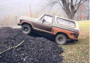 1979 Ford Bronco - This 1978 Ford Bronco is captured in a three-quarter front view as it ascends a mound of coal.