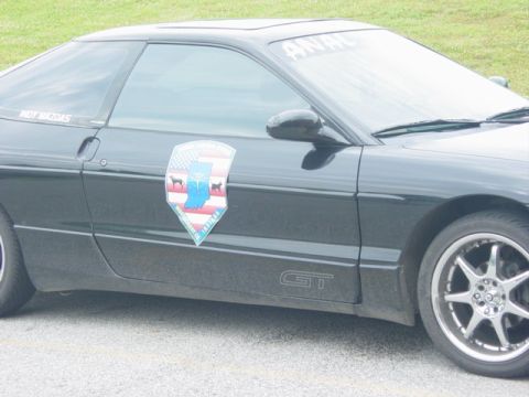 1995 Ford Probe - Side view of a black 1995 Ford Probe GT, a custom decal and windshield banner.