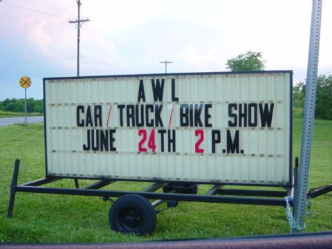1995 Ford Probe - A portable marquee sign announces a car, truck, and bike show event.