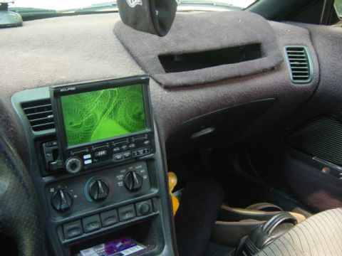 1995 Ford Probe - Interior view of a car's dashboard an aftermarket screen and climate controls.
