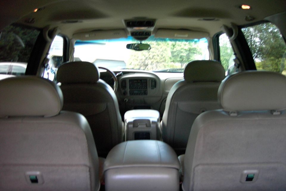 Interior rear view of full-size Ford SUV with tan leather seats and headrests