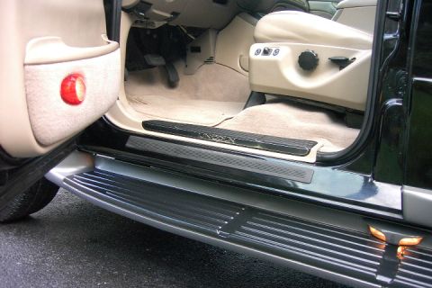 1996 Mercury Grand Marquis - The interior of a vehicle is visible, including the driver's seat, door panel, and running boards.