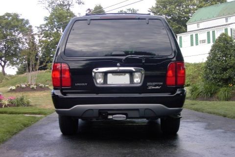 1996 Mercury Grand Marquis - Rear view of a black Lincoln Navigator Limited SUV, tinted windows and chrome detailing on the tailgate.