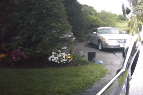 1996 Mercury Grand Marquis - Silver sedan parked on driveway with flowers and bushes nearby; another vehicle is in the foreground.