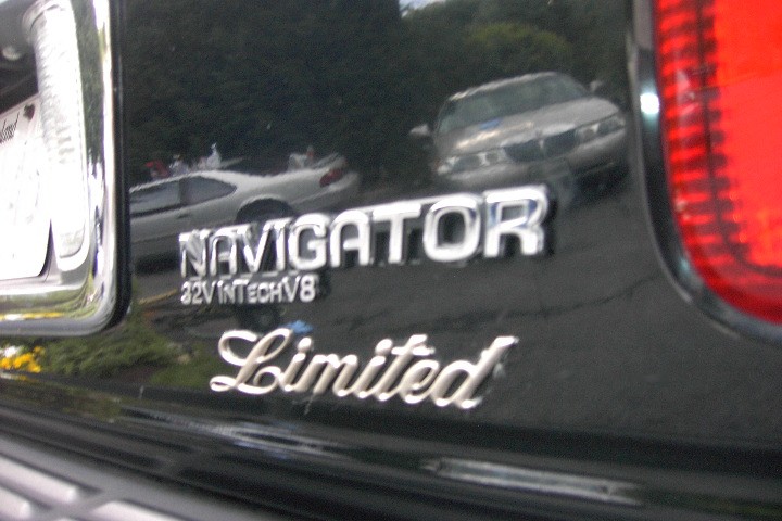 Chrome "Navigator Limited" badge on glossy black tailgate with taillight