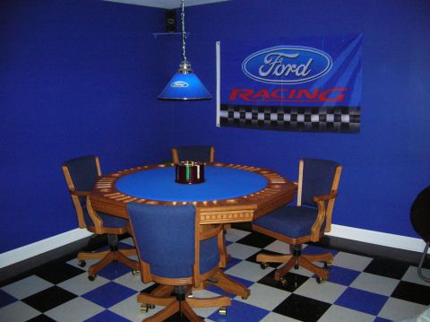 1994 Ford Bronco - A room decorated with Ford Racing memorabilia, a poker table and chairs.