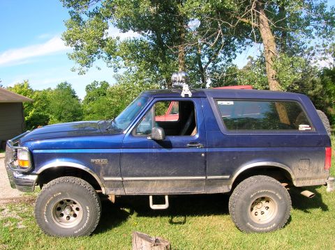 1994 Ford Bronco - This 1994 Ford Bronco is shown in profile, equipped with off-road tires and auxiliary lights on its roof.