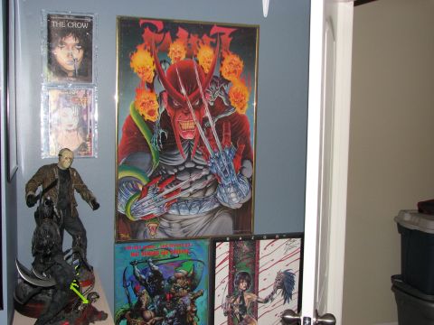 1991 Ford Bronco - A collection of pop culture memorabilia, including framed artwork and action figures, is displayed on a wall.