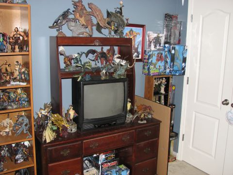 1991 Ford Bronco - A room filled with various collectible figures and models, including dragons and humanoids, displayed on furniture.