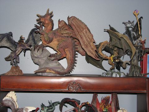 1991 Ford Bronco - A collection of fantasy dragon figurines are displayed on a wooden shelf.